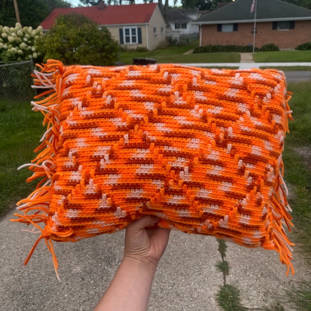 crocheted pillow with fringe